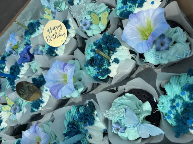 Cupcakes piped in blue buttercream flowers