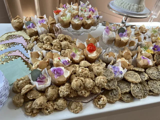 Cookies and dessert cups crowded across the table