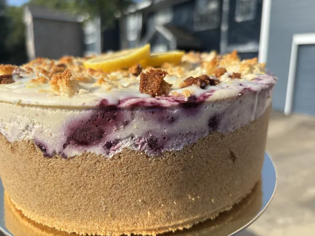 A whole blueberry cheesecake finished with lemon and crumble