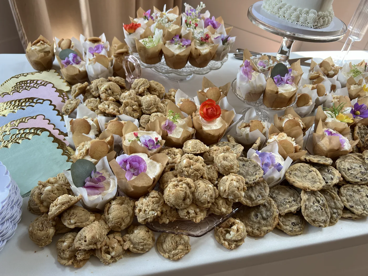 Cookies and dessert cups crowded across the table